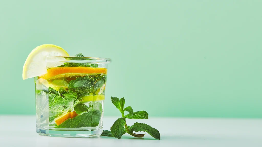 Glass of club soda with lemon and mint